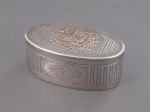 A oval silver and gold snuff box